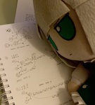 A Yomou fumo lying on a notepad